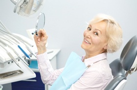 senior woman admiring dentures