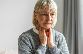 Concerned woman touching her throat