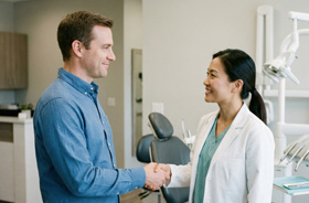 Patient shaking his dentist’s hand