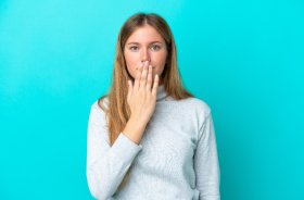 Concerned young woman covering her mouth