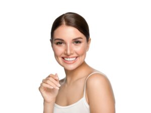 Woman in white tank top smiling with perfect teeth